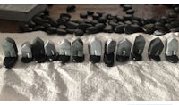 a group of black stones are laid out on a table