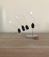 a small sculpture of a house with stars on it