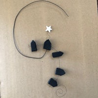 a black and white star hanging on a piece of cardboard