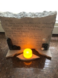 a stone plaque with a candle on it