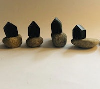 a group of rocks with black crystals on them