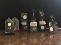 a group of small black and white figurines on a table