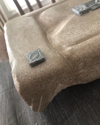 a piece of wood with a piece of metal on it