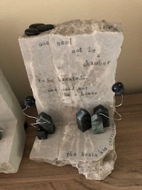 two sculptures with a quote on them