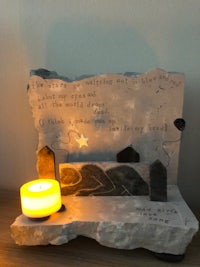 a piece of stone with a candle on it