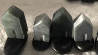 a group of black and gray stones on a table